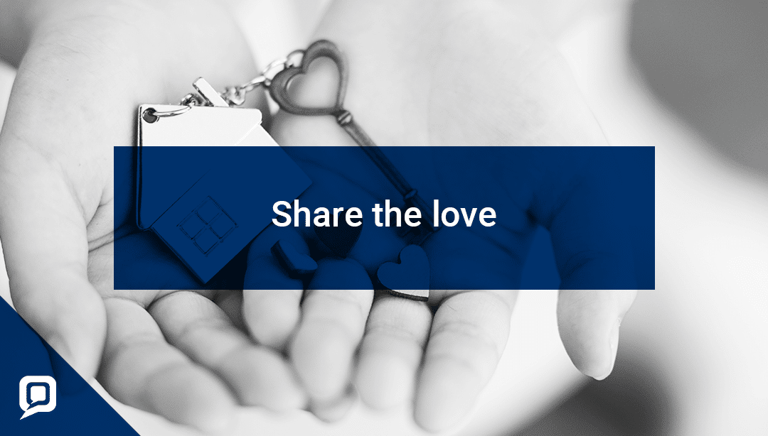 Black and white image of hands holding a house keyring and key with 'Share the love' written over it